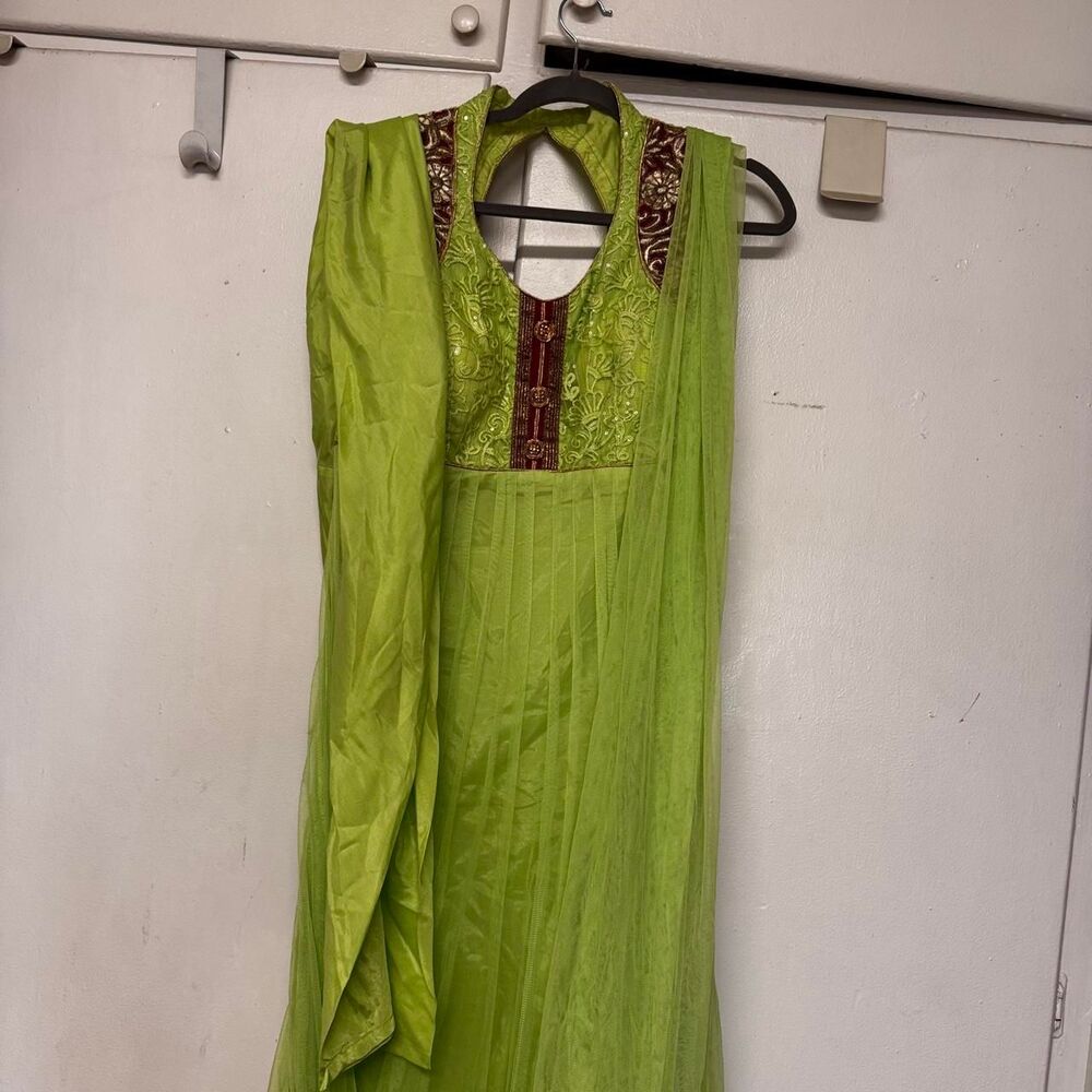 Green and red embroidered dress with gold trim and red velvet accents